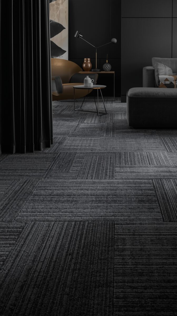 Modern dark interior with grey carpet tiles, brown leather chair, black curtains, and minimalist decor with task lighting