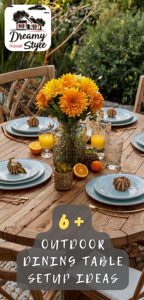 Outdoor wooden dining table set with blue plates, yellow-orange flowers in mason jar, oranges, and pine cones